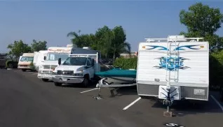 Cars, trucks, boats, RVs and trailers parked in outdoor storage spaces
